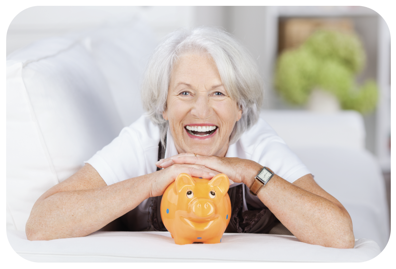 Smiling senior woman with piggy bank sitting on the sofa 